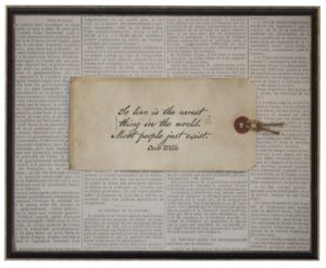 Sepia tag with Oscar Wilde To Live quote on newsprint