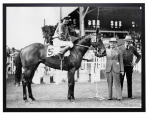 Vintage black and white photograph of a horse and jockey